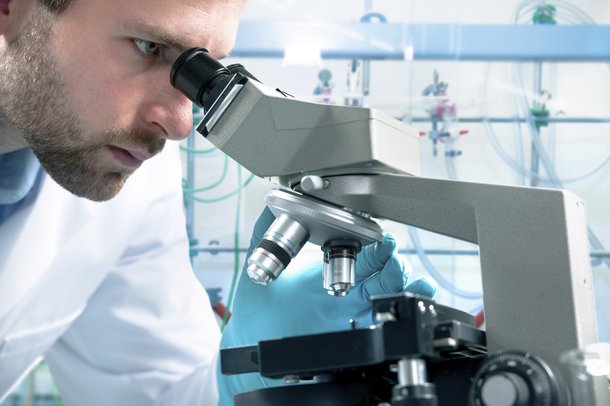 Microscope and scientist people istock